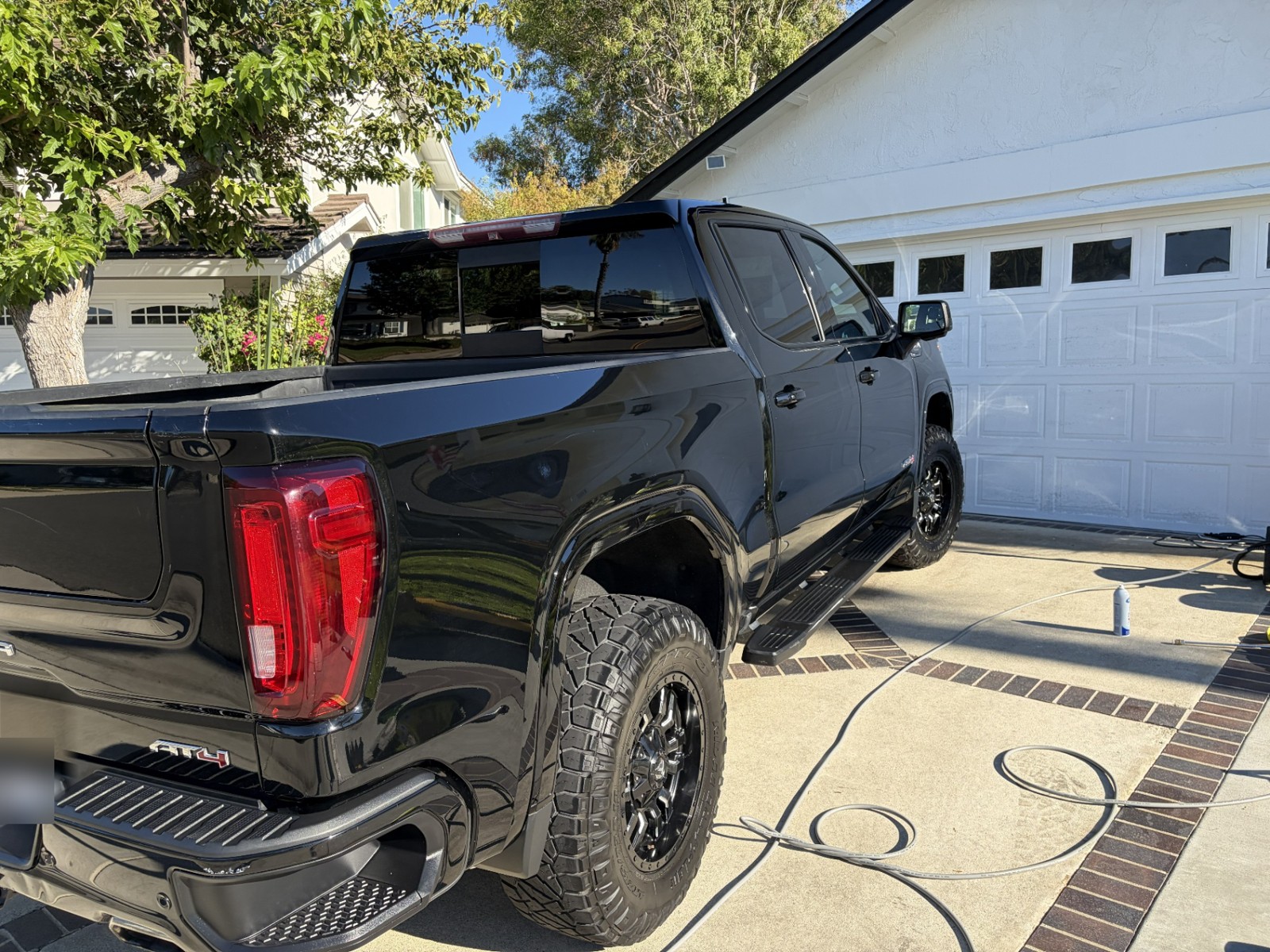 Detailed black GMC Sierra AT4 in a driveway